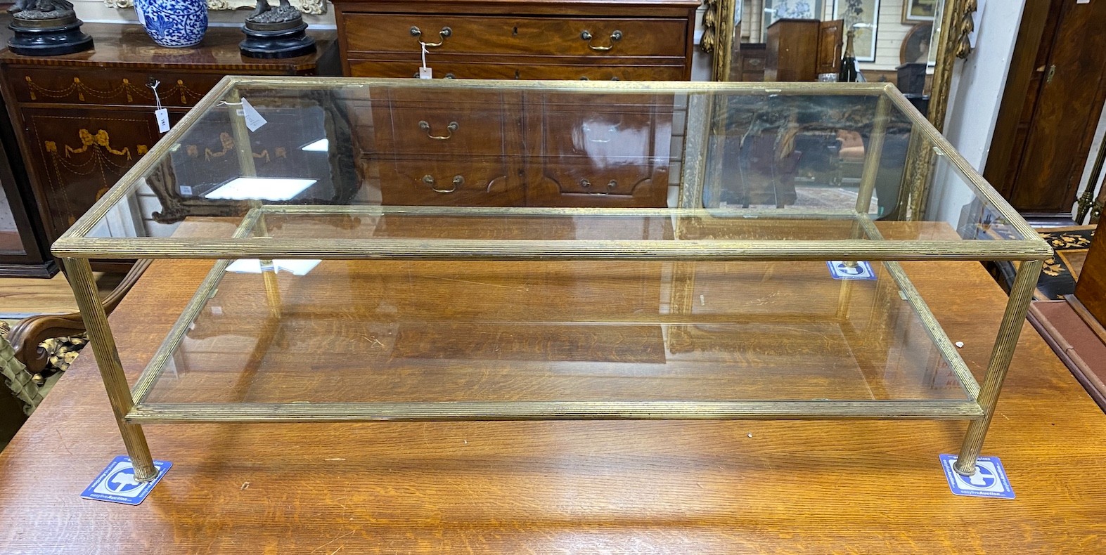 A Maison Jansen style rectangular glass and brass two tier coffee table, length 130cm, depth 70cm, height 41cm